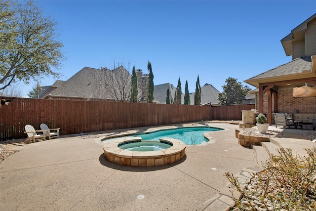 view of swimming pool featuring a pool with connected hot tub, a fenced backyard, and a patio area