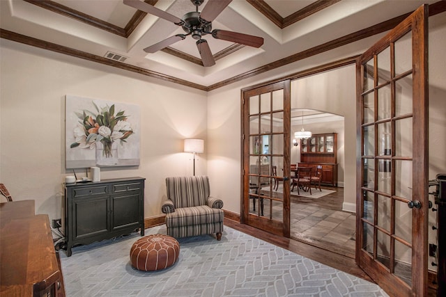 sitting room featuring french doors, visible vents, and ornamental molding