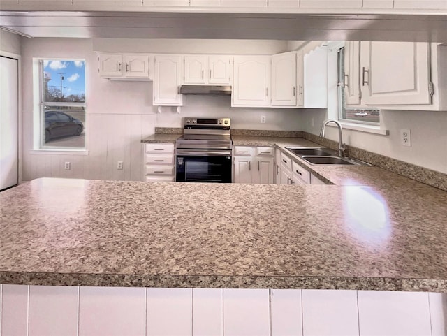 kitchen with stainless steel range with electric stovetop, white cabinetry, a sink, and under cabinet range hood