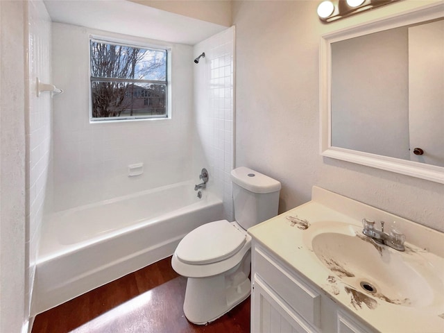 full bath featuring toilet, bathing tub / shower combination, wood finished floors, and vanity