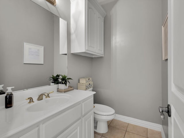 bathroom featuring vanity, tile patterned floors, toilet, and baseboards