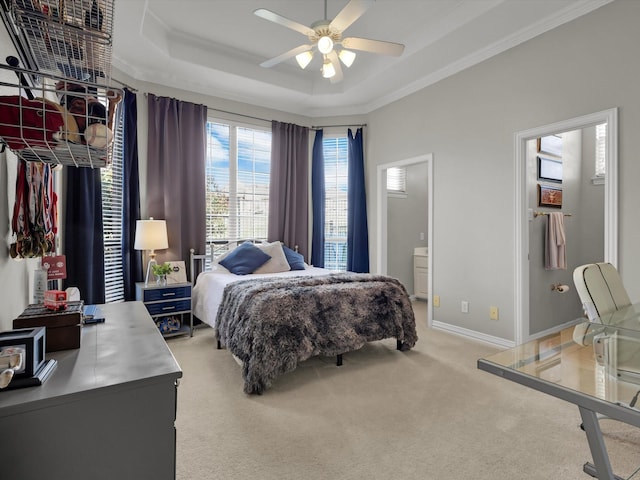 bedroom with light carpet, a raised ceiling, ornamental molding, baseboards, and ceiling fan