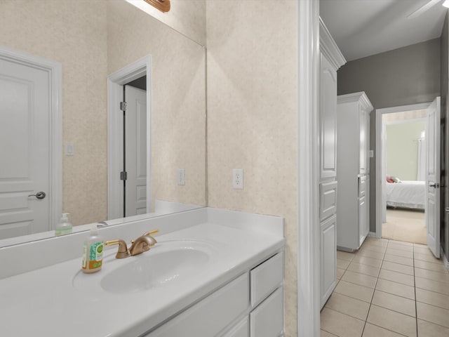 bathroom featuring tile patterned floors, wallpapered walls, and vanity