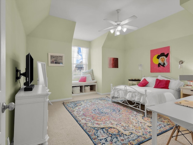 carpeted bedroom featuring baseboards, ceiling fan, and vaulted ceiling