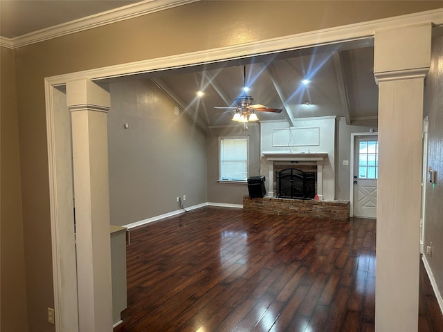 unfurnished living room featuring vaulted ceiling with beams, a wealth of natural light, dark wood-type flooring, a brick fireplace, and ceiling fan