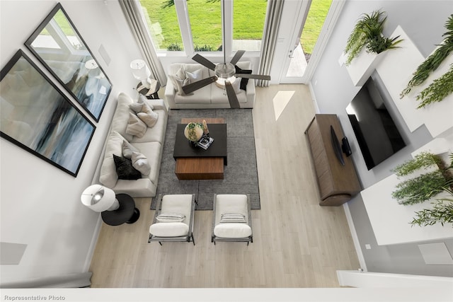 living area featuring wood finished floors and a ceiling fan