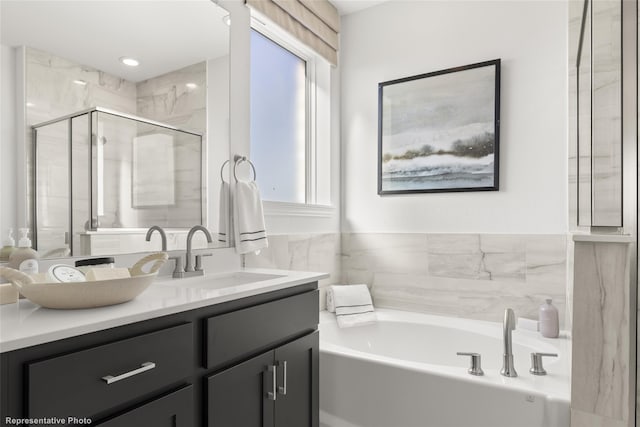 bathroom featuring a bath, a stall shower, vanity, and recessed lighting