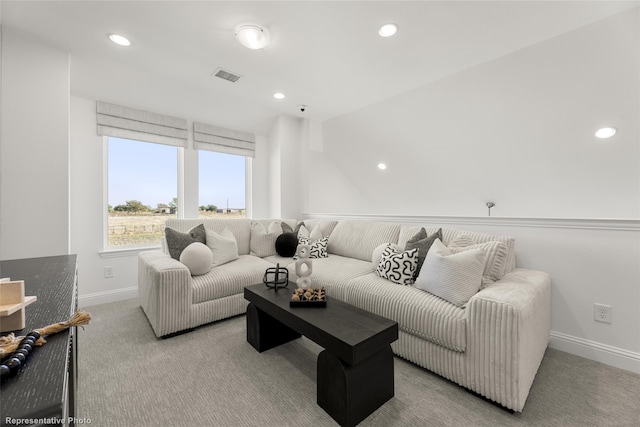 carpeted living room featuring recessed lighting, visible vents, and baseboards