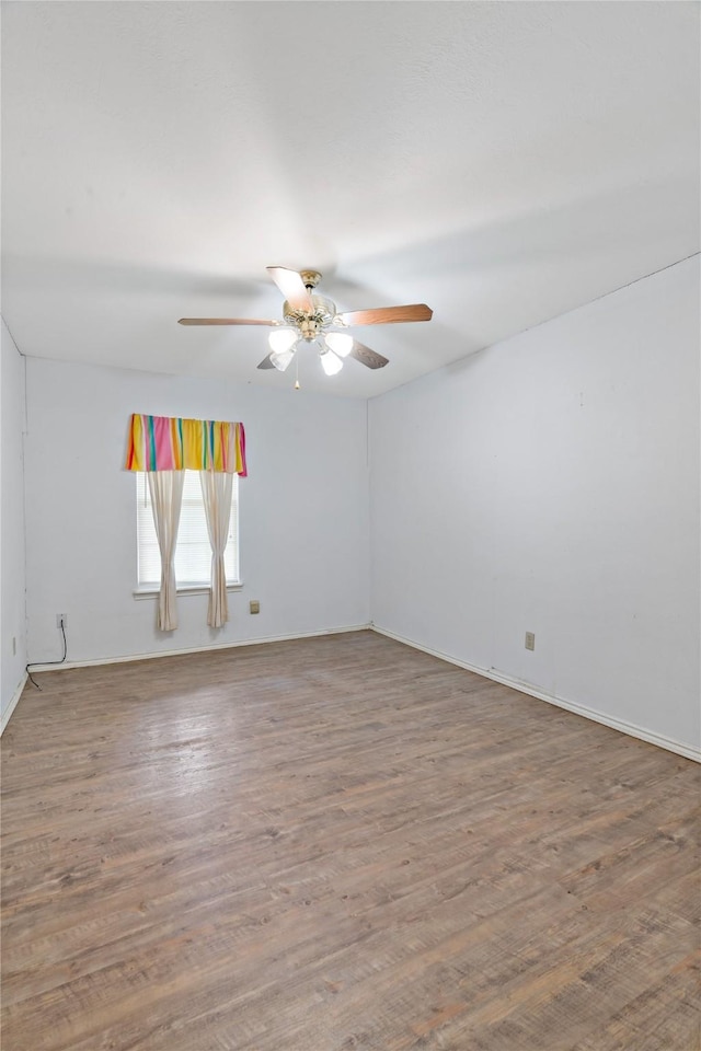 spare room featuring a ceiling fan and wood finished floors