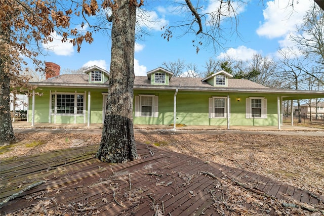 view of front of property featuring an attached carport and a chimney