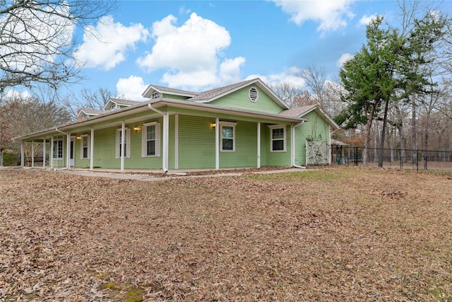 view of front of property with a porch and fence