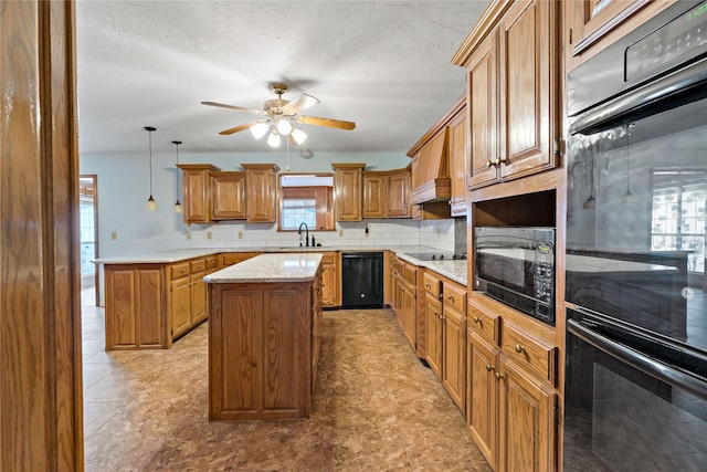 kitchen with a sink, backsplash, a center island, black appliances, and brown cabinetry