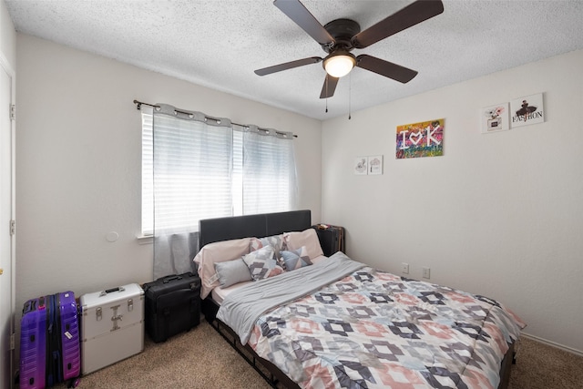 carpeted bedroom with a ceiling fan and a textured ceiling