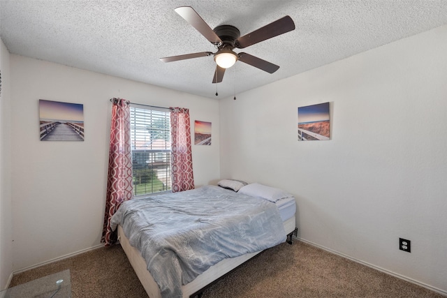 carpeted bedroom featuring a textured ceiling and ceiling fan