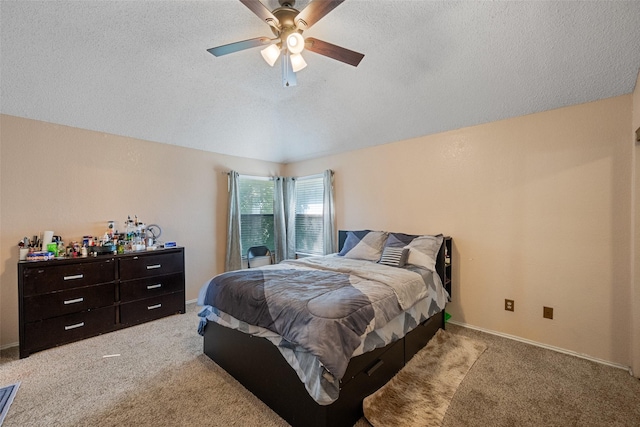 bedroom with light carpet, ceiling fan, and a textured ceiling