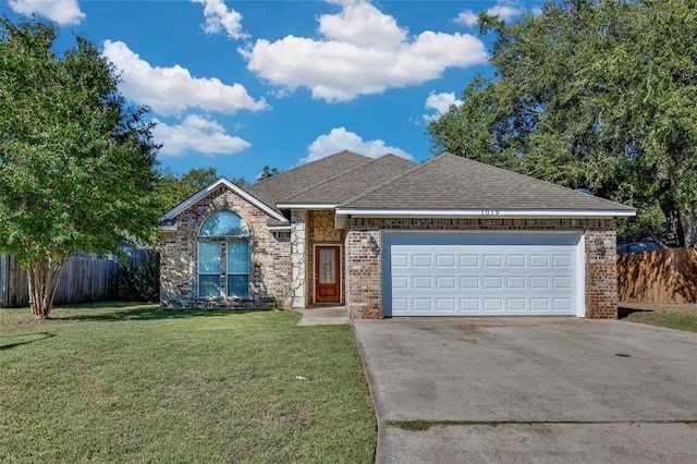 ranch-style home with an attached garage, a front lawn, concrete driveway, and brick siding