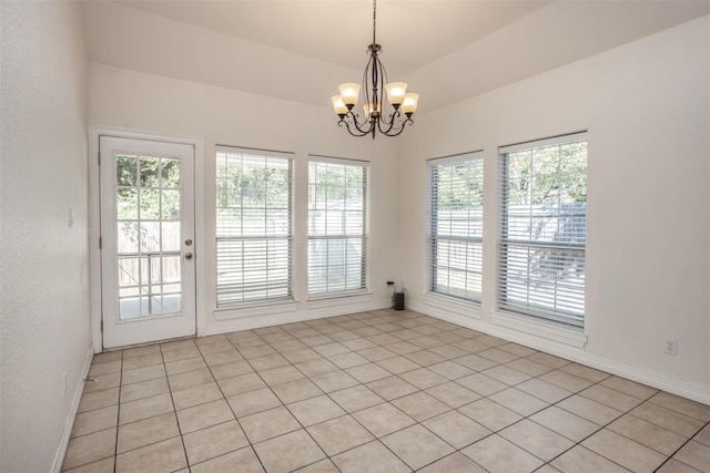 unfurnished room featuring lofted ceiling, a notable chandelier, and baseboards