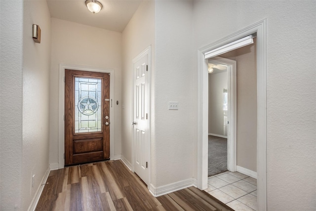 entryway featuring light wood-style flooring and baseboards