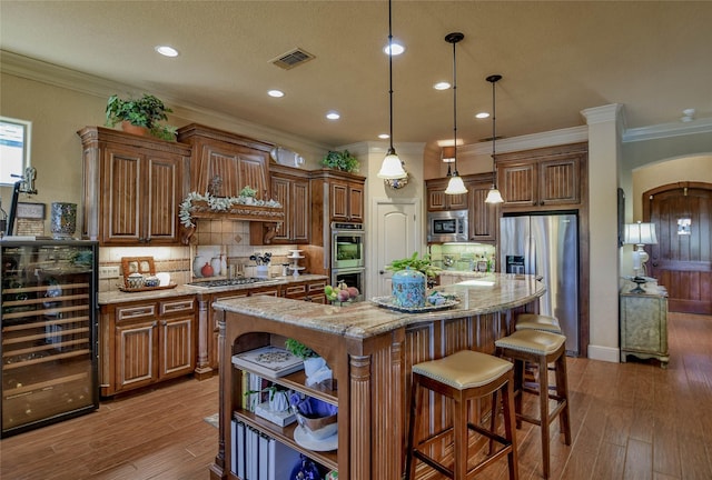 kitchen with visible vents, arched walkways, wine cooler, appliances with stainless steel finishes, and open shelves