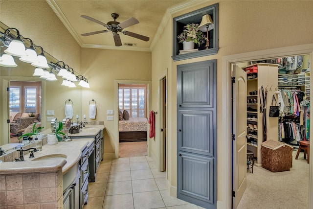 ensuite bathroom with double vanity, ornamental molding, a sink, ensuite bath, and tile patterned floors