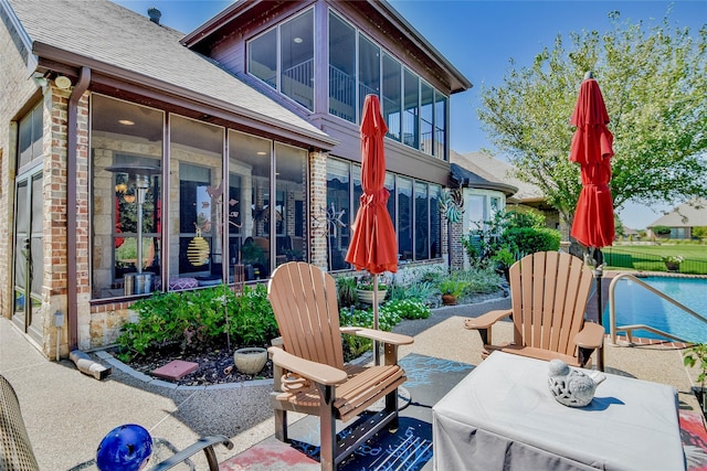 view of patio with a sunroom and a fenced in pool