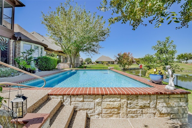 view of pool with a fenced in pool and fence