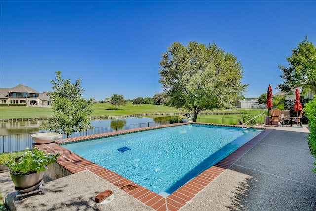 view of swimming pool featuring a lawn, a fenced in pool, a patio, a fenced backyard, and a water view