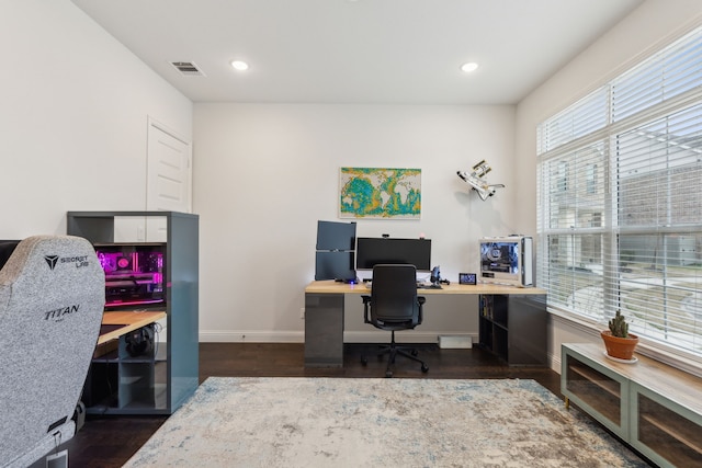 office space with baseboards, visible vents, dark wood-type flooring, and recessed lighting