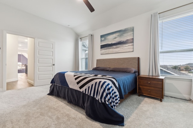 bedroom with carpet, ceiling fan, lofted ceiling, and baseboards