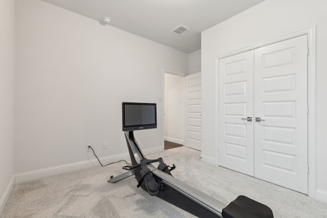 workout area with carpet, visible vents, and baseboards