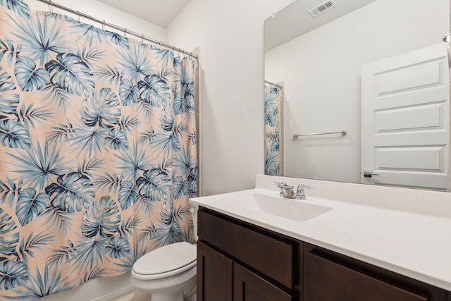 bathroom featuring toilet, vanity, and visible vents