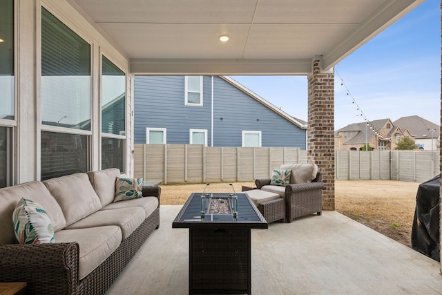 view of patio featuring a fenced backyard and an outdoor living space with a fire pit