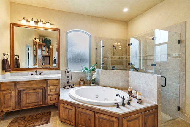 full bathroom featuring vanity, a shower stall, a whirlpool tub, and tile patterned floors