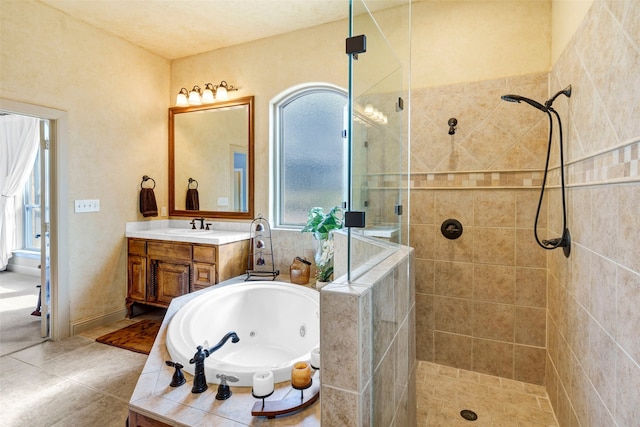 full bath with tile patterned flooring, a tile shower, a jetted tub, and vanity