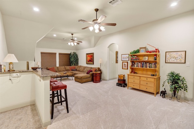 living area featuring visible vents, arched walkways, light colored carpet, ceiling fan, and recessed lighting