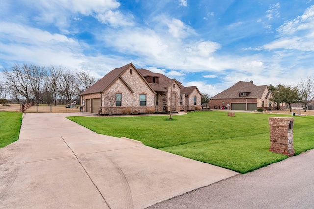 french provincial home featuring a front yard, stone siding, driveway, and an attached garage