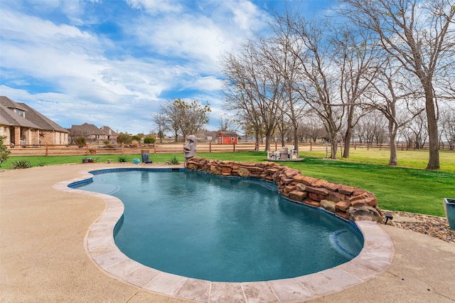 outdoor pool featuring a patio area, fence, and a lawn