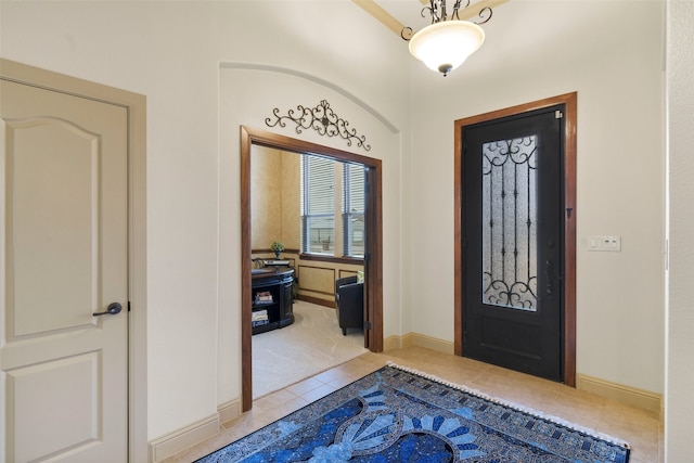 foyer with light tile patterned floors and baseboards