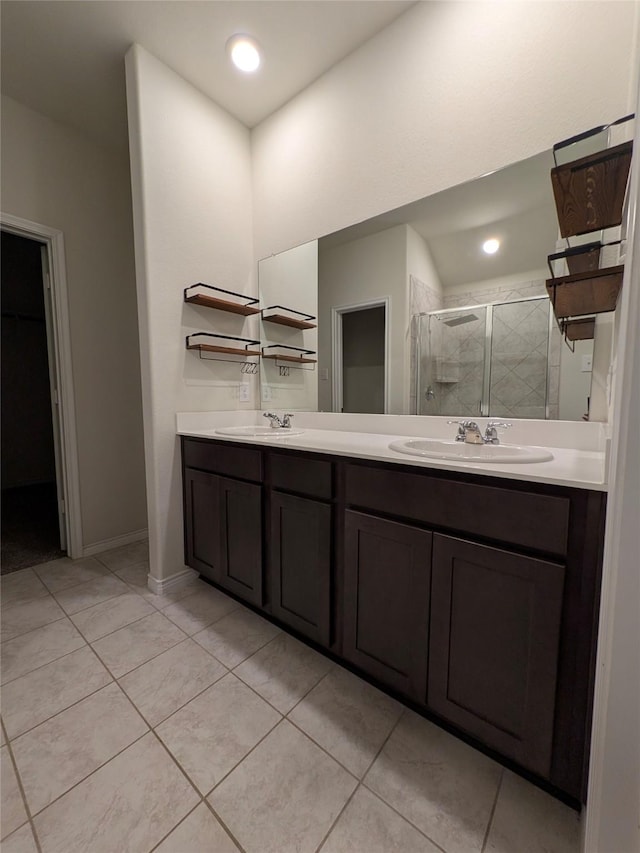 bathroom with a stall shower, tile patterned flooring, a sink, and double vanity