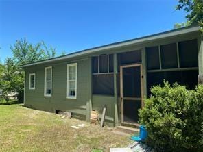 rear view of property with a lawn