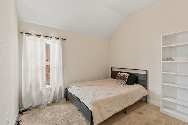 carpeted bedroom with lofted ceiling