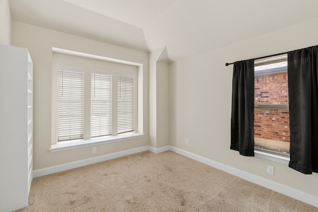 carpeted empty room with plenty of natural light and baseboards