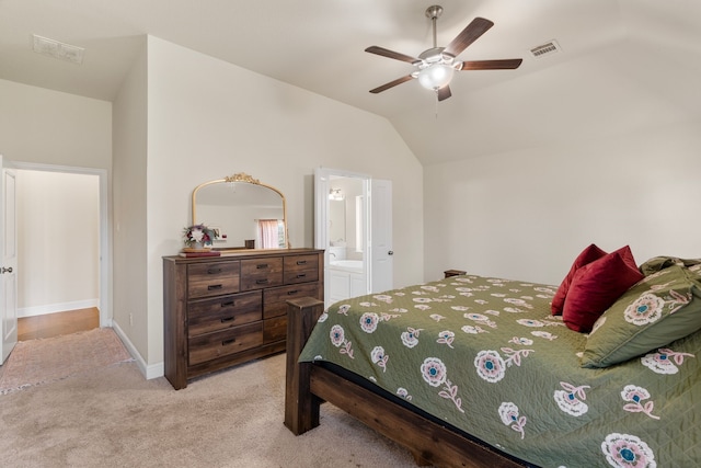 carpeted bedroom featuring lofted ceiling, connected bathroom, visible vents, baseboards, and a ceiling fan