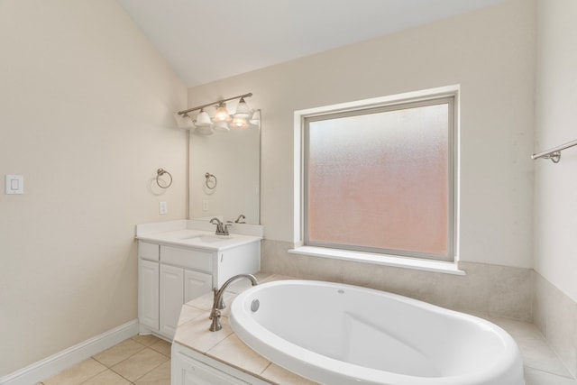 full bathroom featuring a tub to relax in, vanity, baseboards, vaulted ceiling, and tile patterned floors