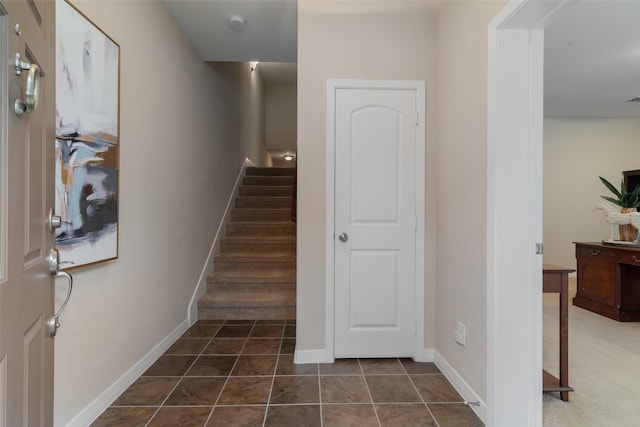 stairway with tile patterned flooring and baseboards