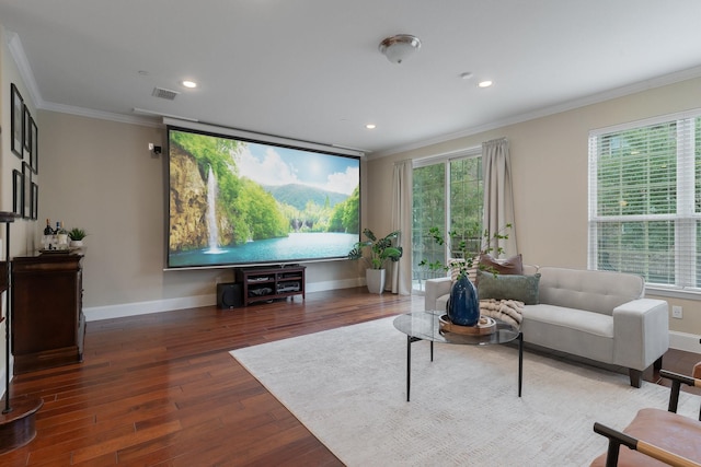 living area featuring baseboards, plenty of natural light, ornamental molding, and wood finished floors