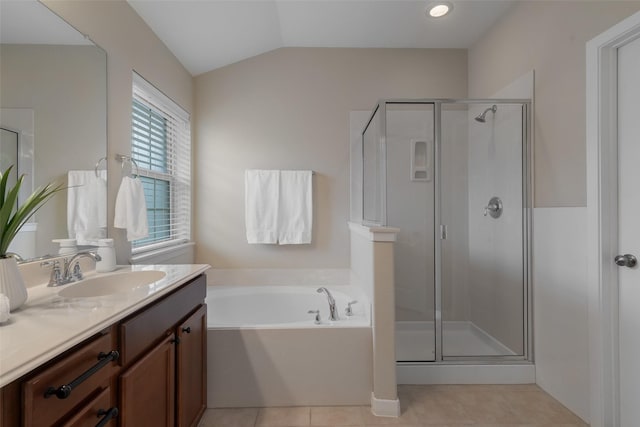 bathroom with lofted ceiling, a garden tub, tile patterned flooring, vanity, and a shower stall