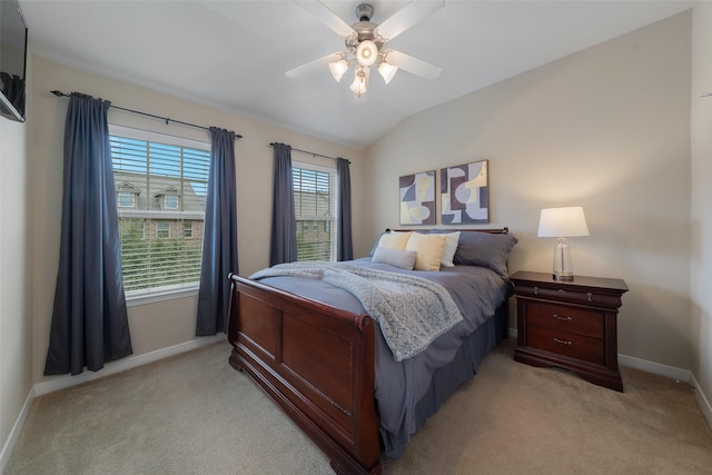 bedroom with light carpet, ceiling fan, vaulted ceiling, and baseboards