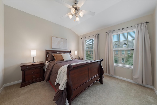 bedroom featuring light carpet, baseboards, vaulted ceiling, and a ceiling fan