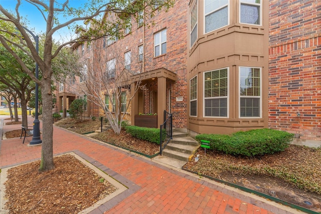 view of exterior entry with brick siding